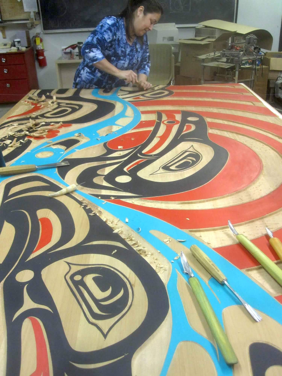 Arlene Ness is an indigenous artist and a member of the outdoor artist collective. In this photo she is in her art studio creating aboriginal art 