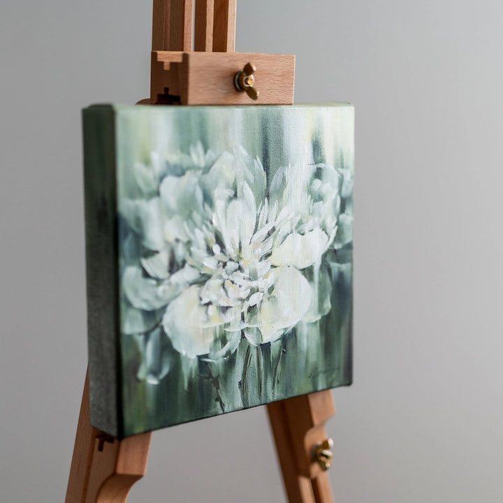 Painting on easel depicting a flower in the rain. This artwork is available for purchase at the artterra art gallery, and is created by Canadian artist Maria Shanina based in Ottawa, Ontario. Shop for Canadian art online at the Ottawa Art Gallery.